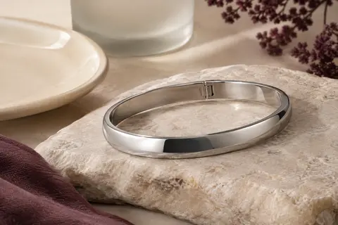 Bracelet jonc ovale argenté en acier inoxydable, poli et doté d’un fermoir articulé discret